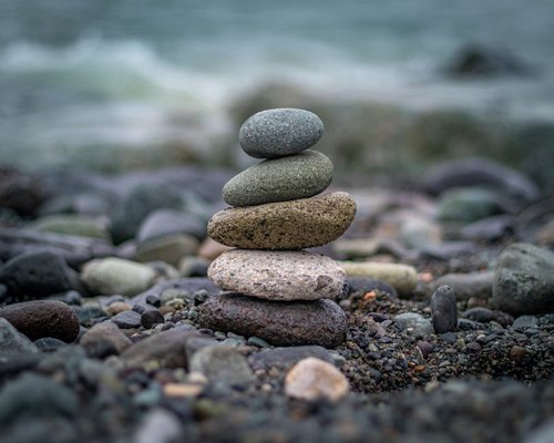 balanced stack of stones on a beach representing stability and harmony